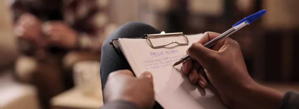 male-psychologist-taking-notes-couple-therapy-session-help-banner