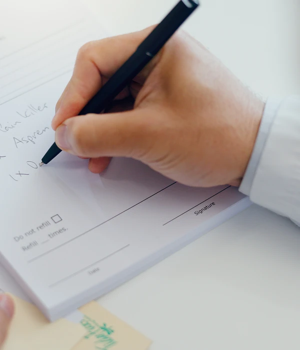 doctor-hands-writing-with-document-prescription-dosage-information-page